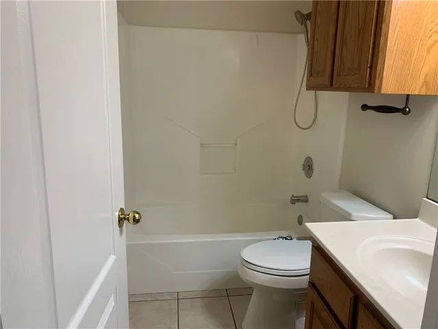 a bathroom with a toilet a sink and shower
