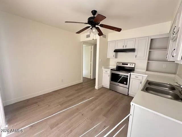 a kitchen with stainless steel appliances a stove a microwave and a refrigerator