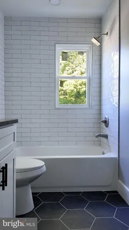 a bathroom with a sink a toilet and a bathtub