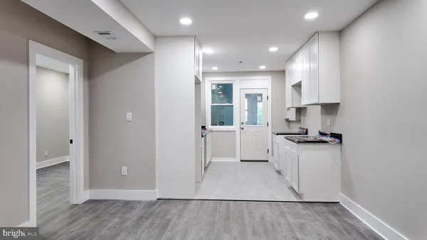 a kitchen with granite countertop a sink and a stove top oven