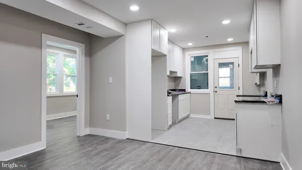a view of a kitchen with a refrigerator and windows