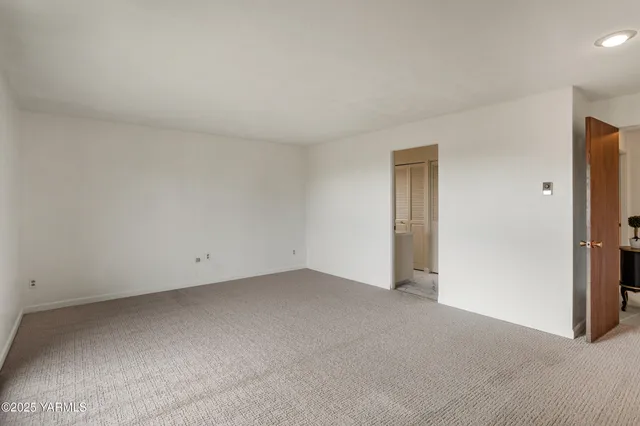 a view of an empty room with glass door