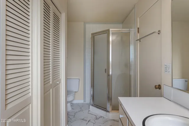 a view of an empty room with closet area