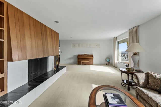 a living room with a bookshelf and a fireplace