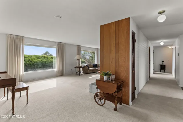 a kitchen with stainless steel appliances granite countertop a stove a refrigerator a sink a dining table and chairs