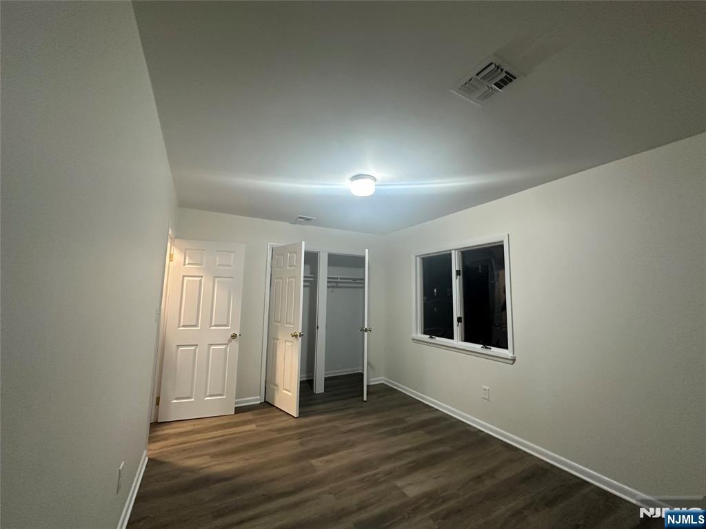 46 Ferry Street, Unit 3F Newark, NJ 07105 - Photo 11 of 14 an empty room with wooden floor and windows