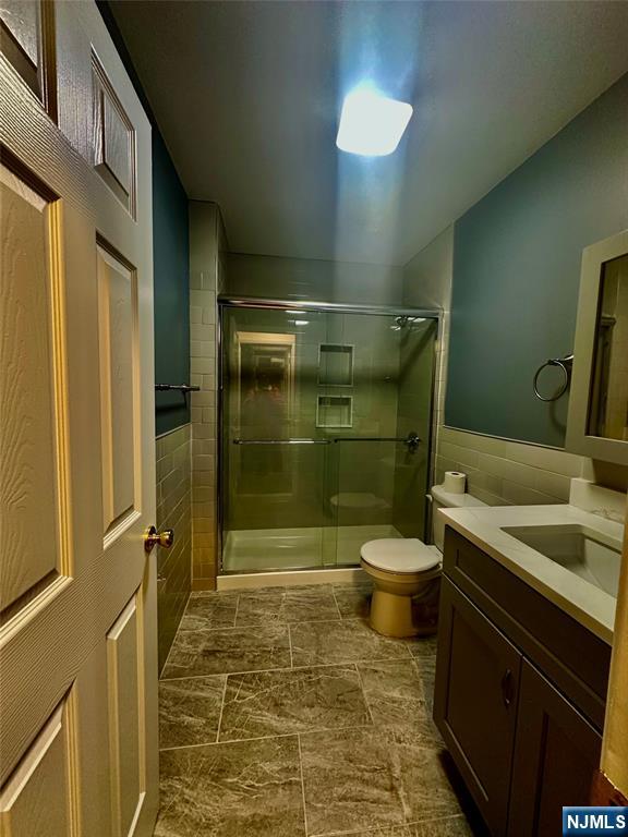 46 Ferry Street, Unit 3F Newark, NJ 07105 - Photo 12 of 14 a bathroom with a granite countertop toilet a sink and shower