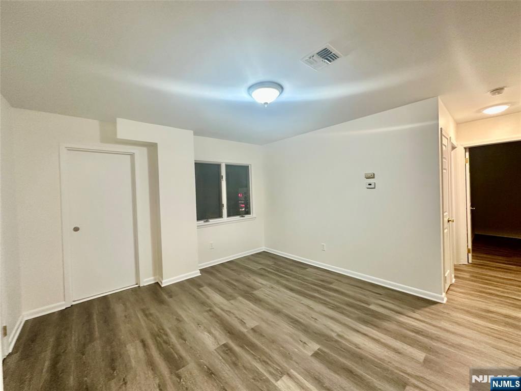 46 Ferry Street, Unit 3F Newark, NJ 07105 - Photo 5 of 14 a view of an empty room with wooden floor and a window