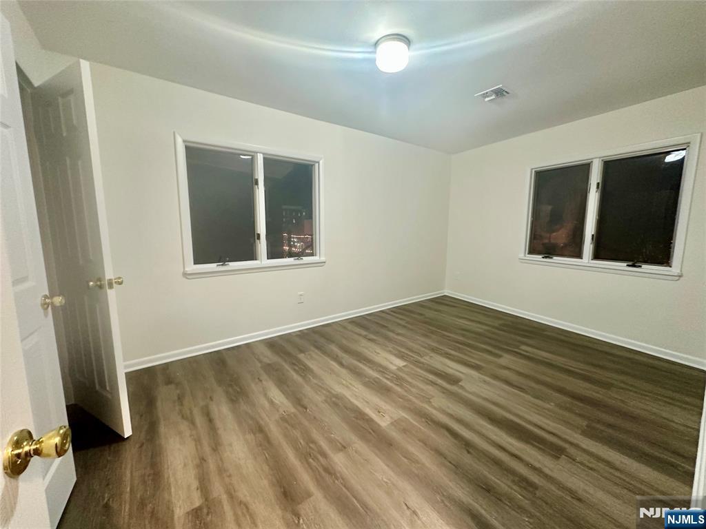 46 Ferry Street, Unit 3F Newark, NJ 07105 - Photo 6 of 14 a view of an empty room with wooden floor and a window