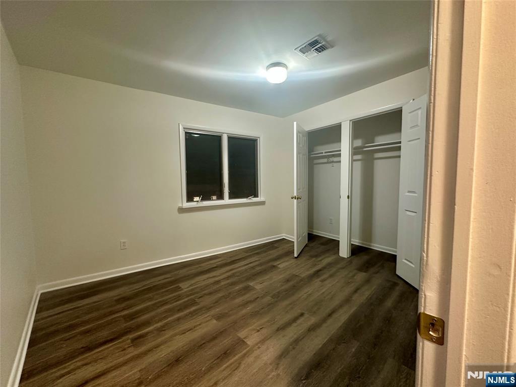 46 Ferry Street, Unit 3F Newark, NJ 07105 - Photo 7 of 14 an empty room with wooden floor and windows