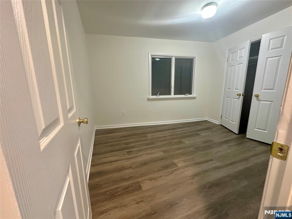 46 Ferry Street, Unit 3F Newark, NJ 07105 - Photo 9 of 14 a view of an empty room with wooden floor and a window