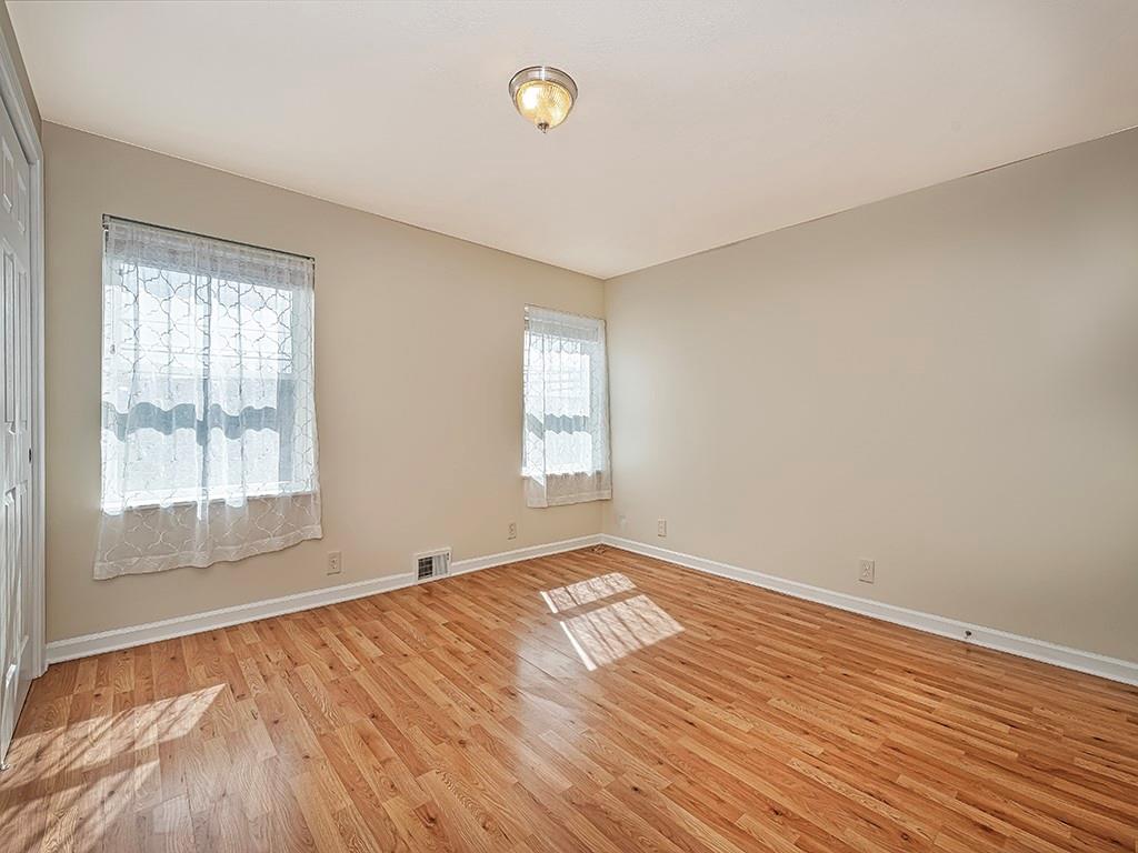 232 New Castle Street Slippery Rock, PA 16057 - Photo 15 of 23 an empty room with wooden floor and windows