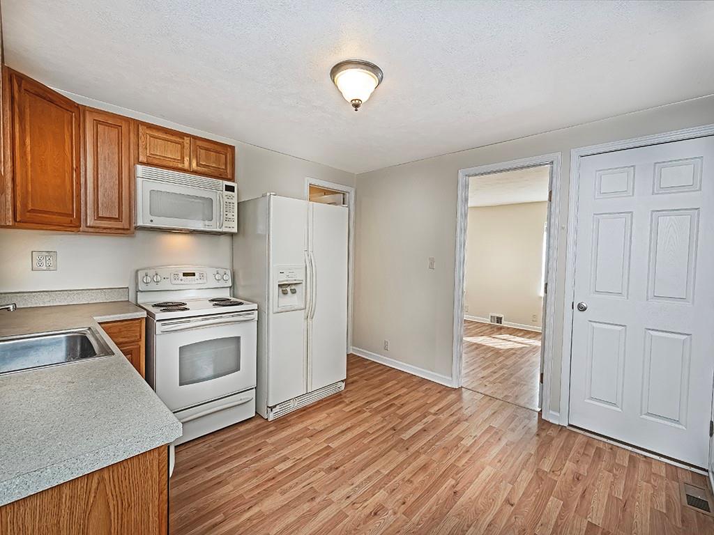 232 New Castle Street Slippery Rock, PA 16057 - Photo 4 of 23 a kitchen with granite countertop a stove and a sink