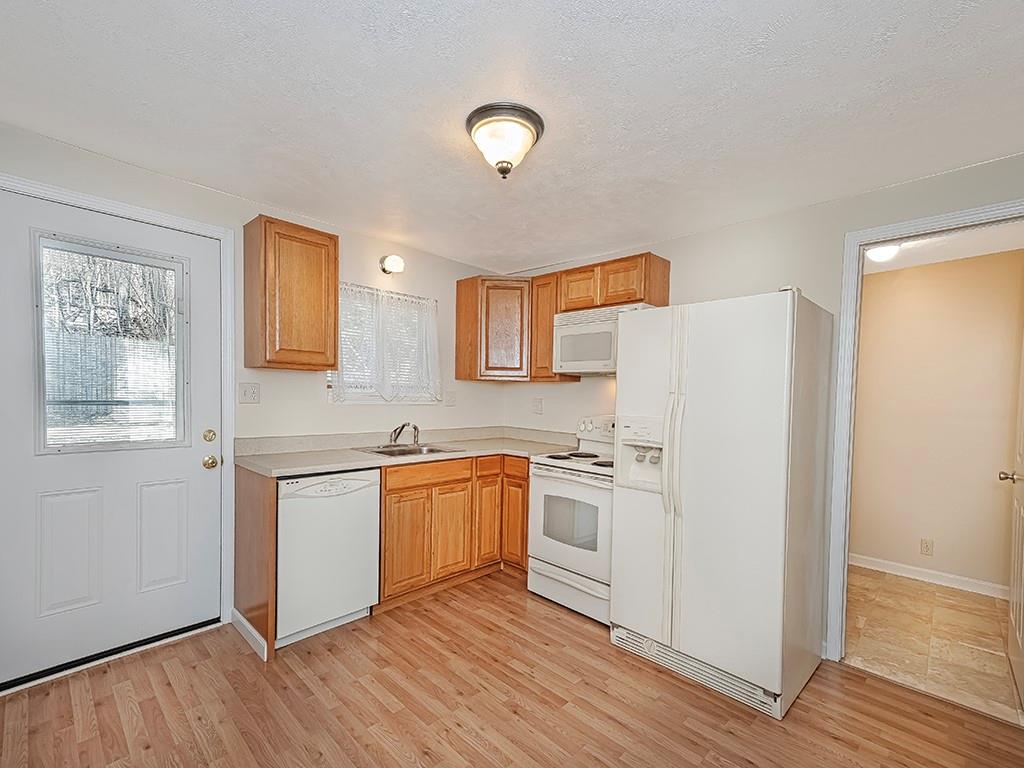 232 New Castle Street Slippery Rock, PA 16057 - Photo 6 of 23 a kitchen with stainless steel appliances granite countertop a stove a sink and a refrigerator