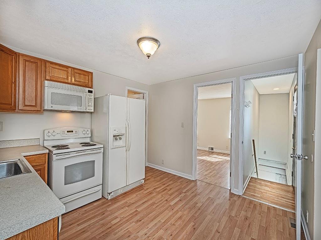 232 New Castle Street Slippery Rock, PA 16057 - Photo 7 of 23 a kitchen with a refrigerator and a stove