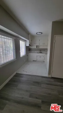 a view of kitchen and hall with wooden floor