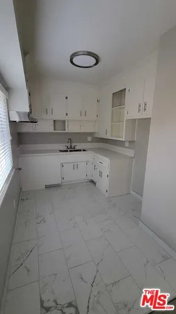 a kitchen with white cabinets