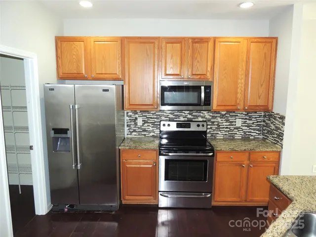 a kitchen with a refrigerator stove and microwave