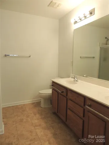 a bathroom with a sink a toilet and mirror