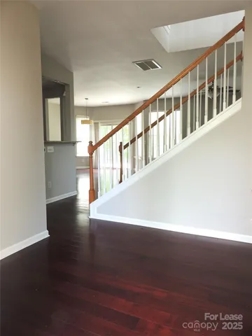 a view of an entryway with wooden floor