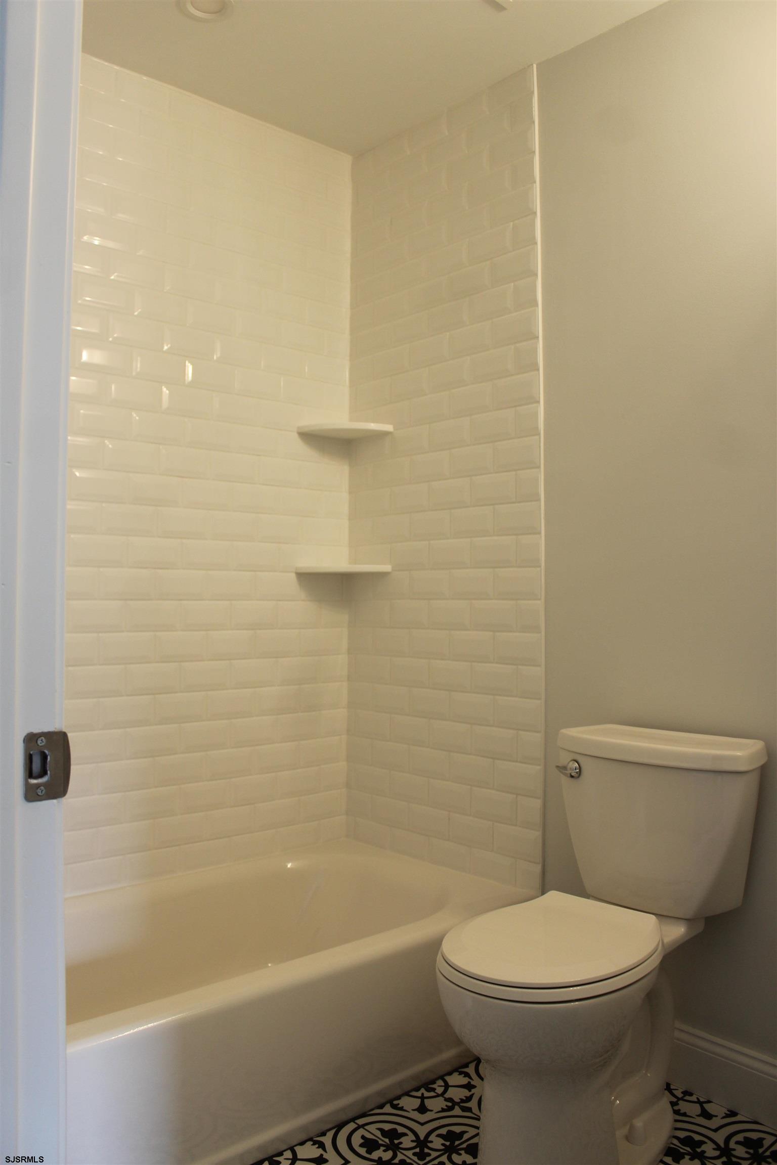 287 New Road Absecon, NJ 08201 - Photo 15 of 29 a bathroom with a toilet and a bathtub