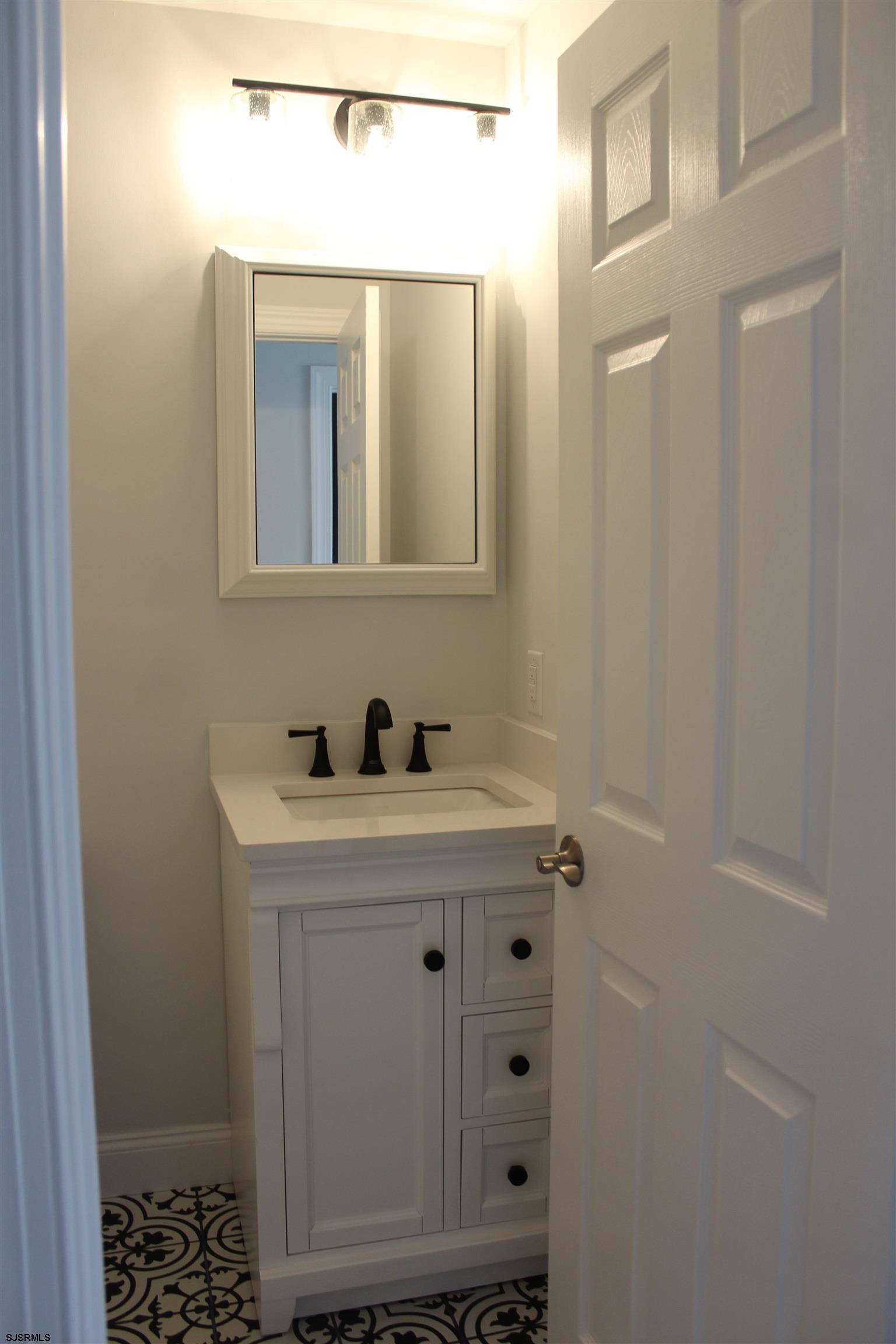 287 New Road Absecon, NJ 08201 - Photo 16 of 29 a bathroom with a sink and a mirror