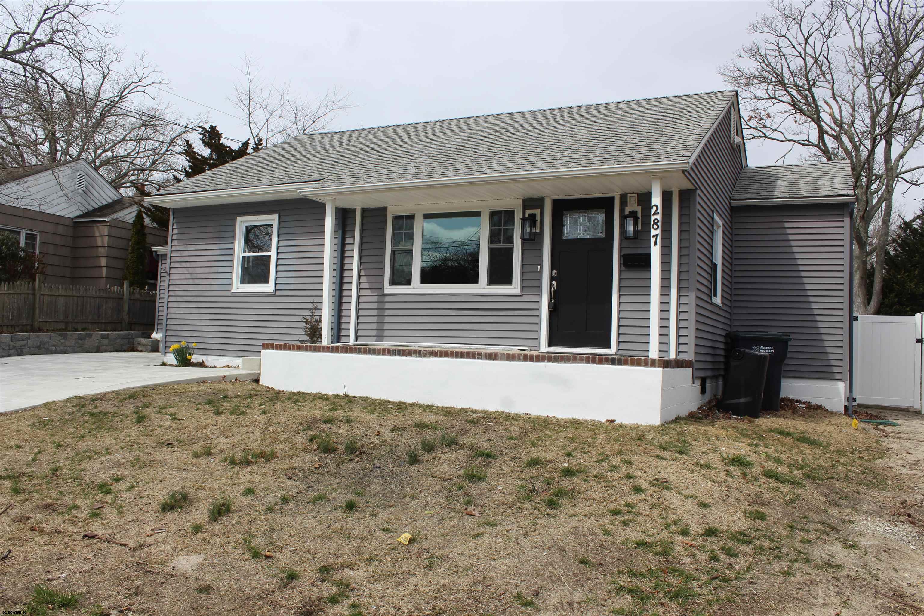 287 New Road Absecon, NJ 08201 - Photo 4 of 29 a front view of a house with a yard and garage