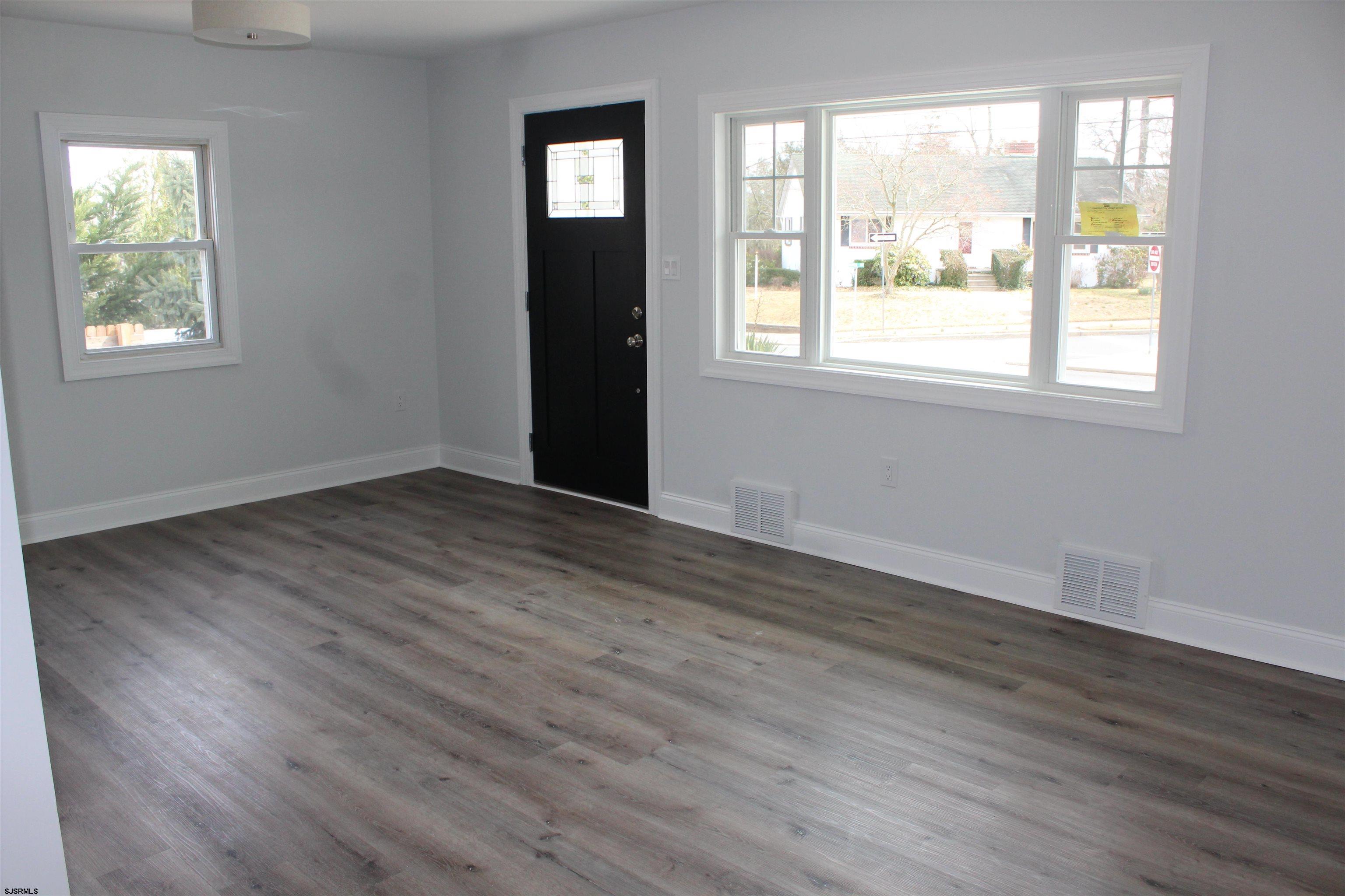 287 New Road Absecon, NJ 08201 - Photo 8 of 29 a view of an empty room with wooden floor and a window