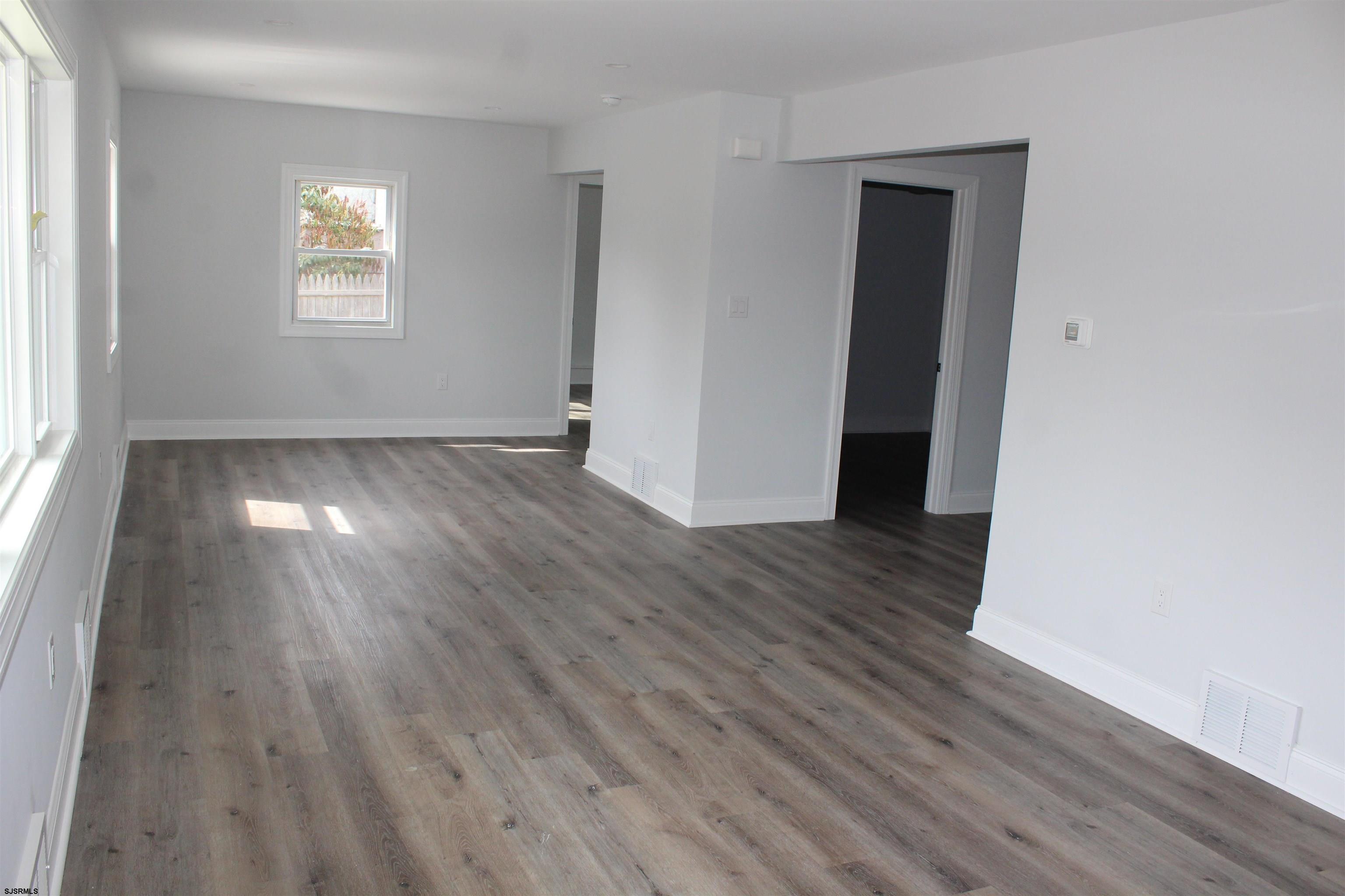 287 New Road Absecon, NJ 08201 - Photo 9 of 29 an empty room with wooden floor and window