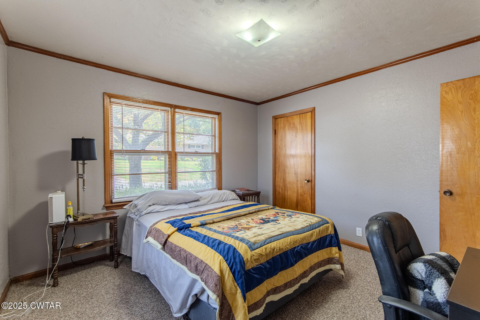 142 South Poplar Street Dyer, TN 38330 - Photo 18 of 28 a bedroom with a bed chair and window