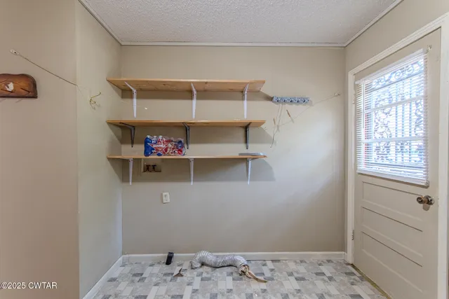 a view of a bedroom with a bed and a window