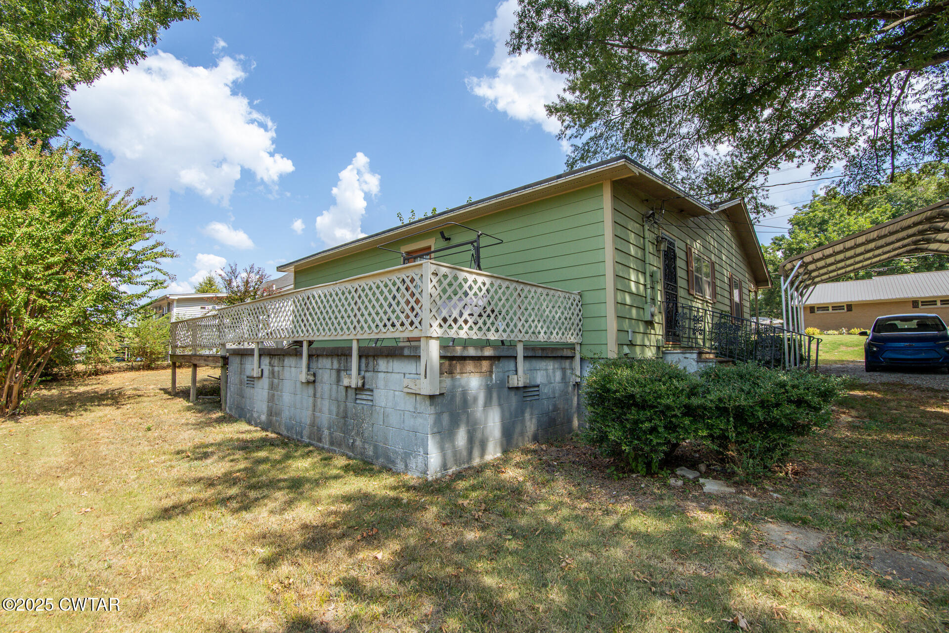 142 South Poplar Street Dyer, TN 38330 - Photo 25 of 28 a backyard of a house with yard and outdoor seating