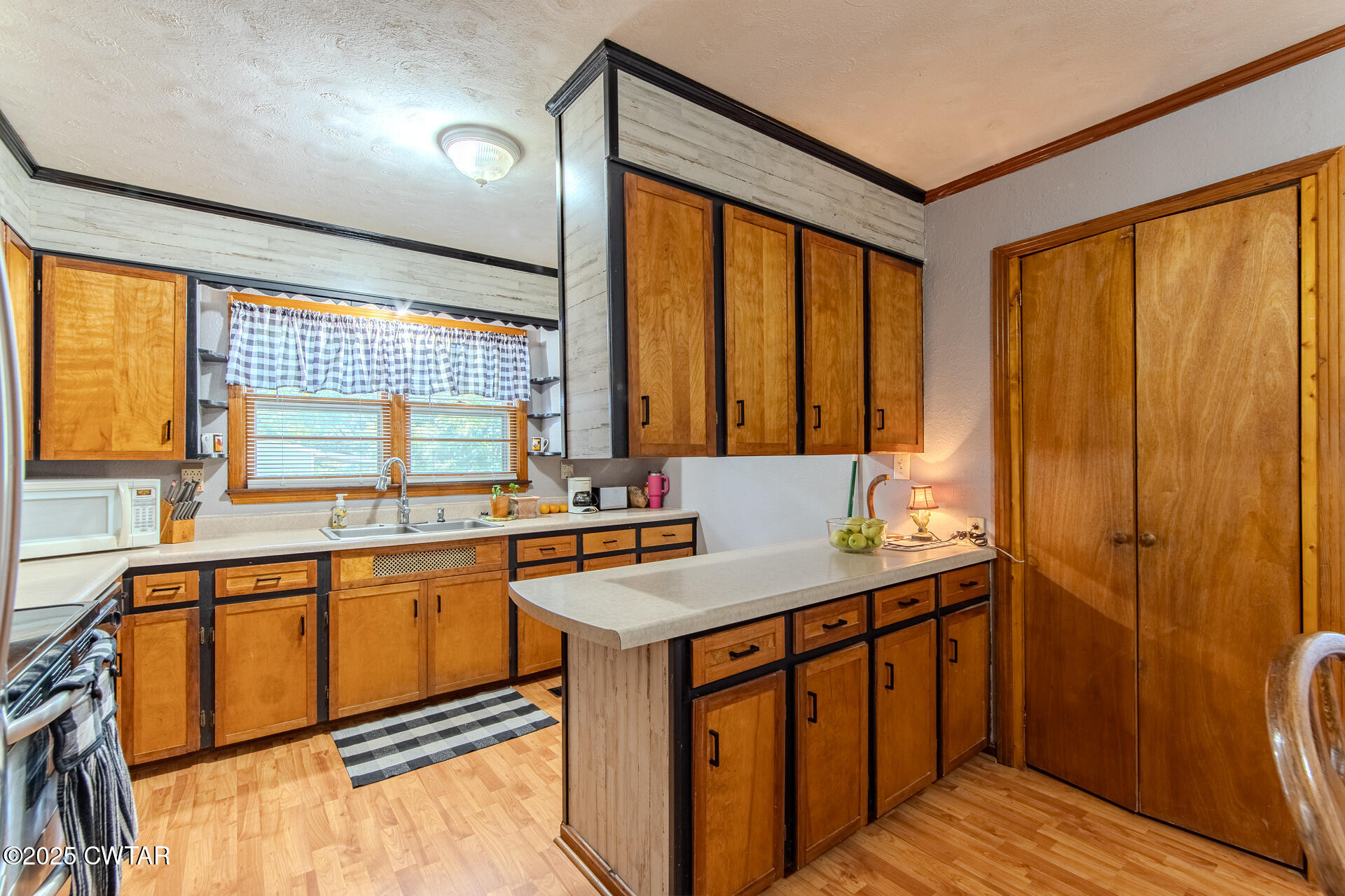 142 South Poplar Street Dyer, TN 38330 - Photo 8 of 28 a kitchen that has a sink and a large window in it