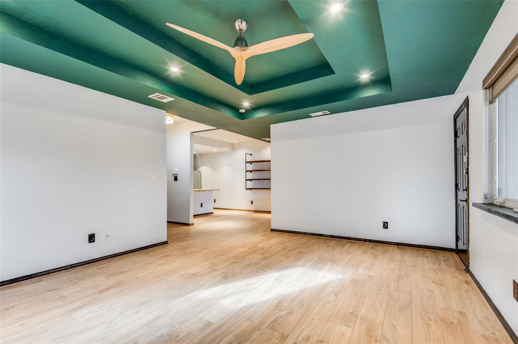 2749 Buna Drive Dallas, TX 75211 - Photo 3 of 12 iving room featuring a tray ceiling, recessed lighting, light wood-style floors, and a ceiling fan