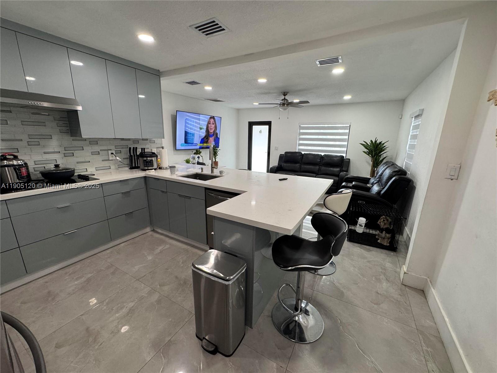 879 East 28th Street, Unit 879 Hialeah, FL 33013 - Photo 3 of 12 a kitchen with a sink stainless steel appliances and cabinets