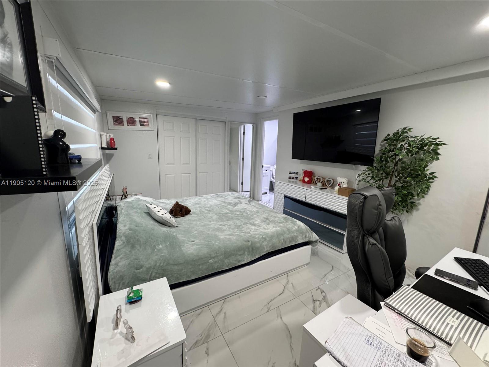 879 East 28th Street, Unit 879 Hialeah, FL 33013 - Photo 5 of 12 a living room with furniture and a flat screen tv