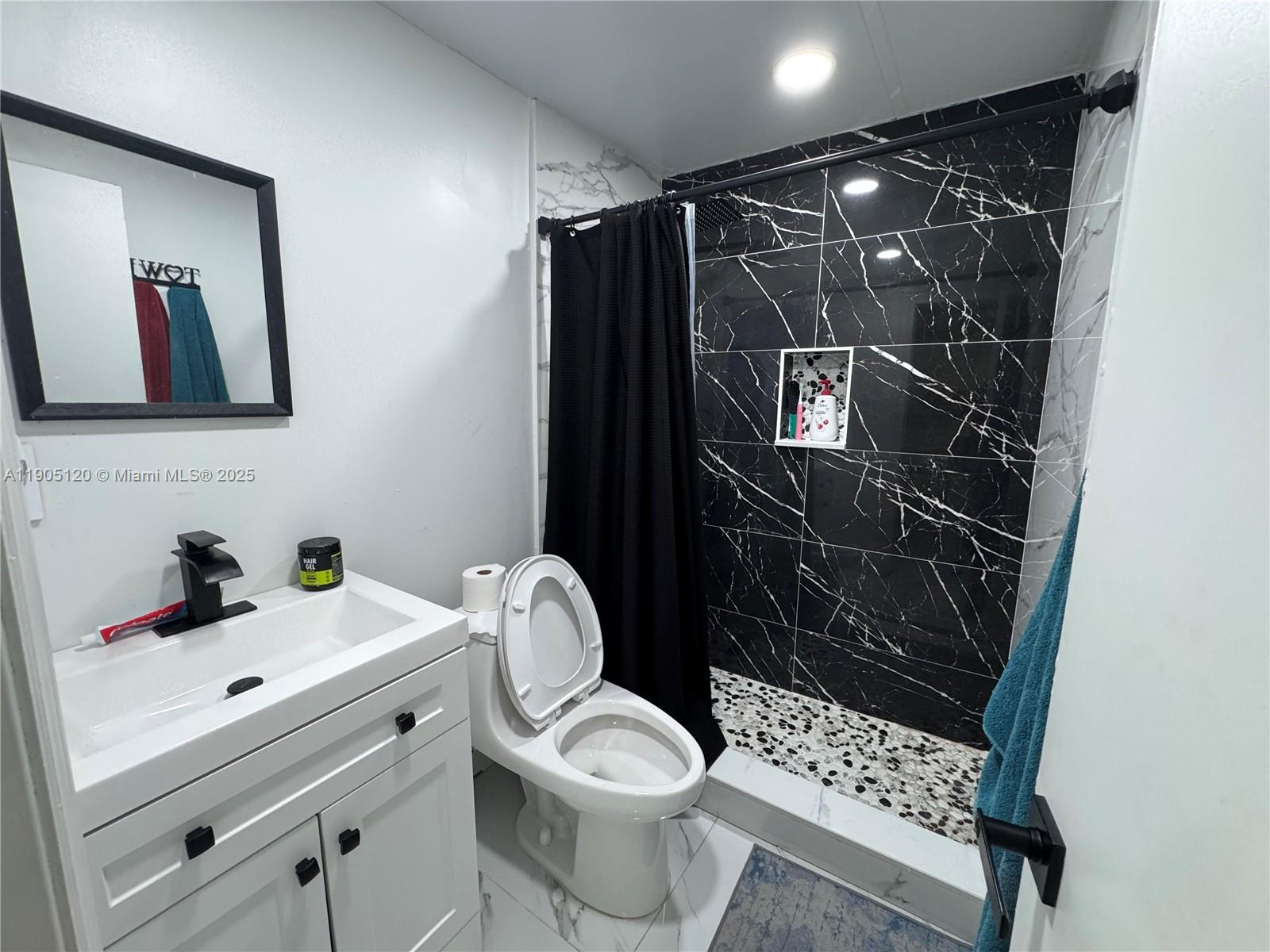 879 East 28th Street, Unit 879 Hialeah, FL 33013 - Photo 6 of 12 a bathroom with a sink toilet and shower