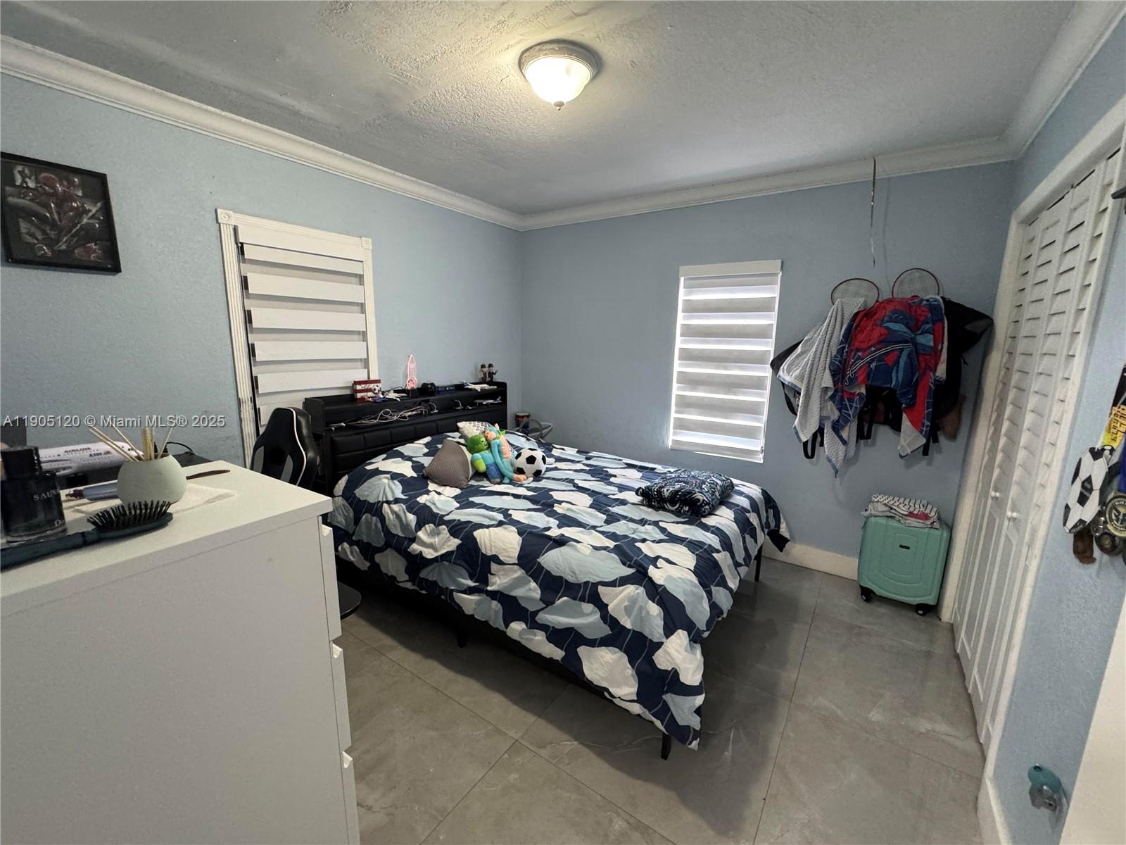 879 East 28th Street, Unit 879 Hialeah, FL 33013 - Photo 8 of 12 a bedroom with bed and a window