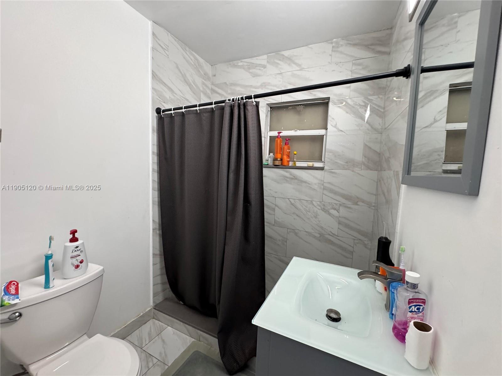 879 East 28th Street, Unit 879 Hialeah, FL 33013 - Photo 9 of 12 a bathroom with a sink toilet and shower