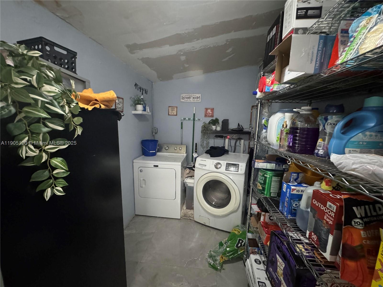 879 East 28th Street, Unit 879 Hialeah, FL 33013 - Photo 10 of 12 a utility room with dryer and washer
