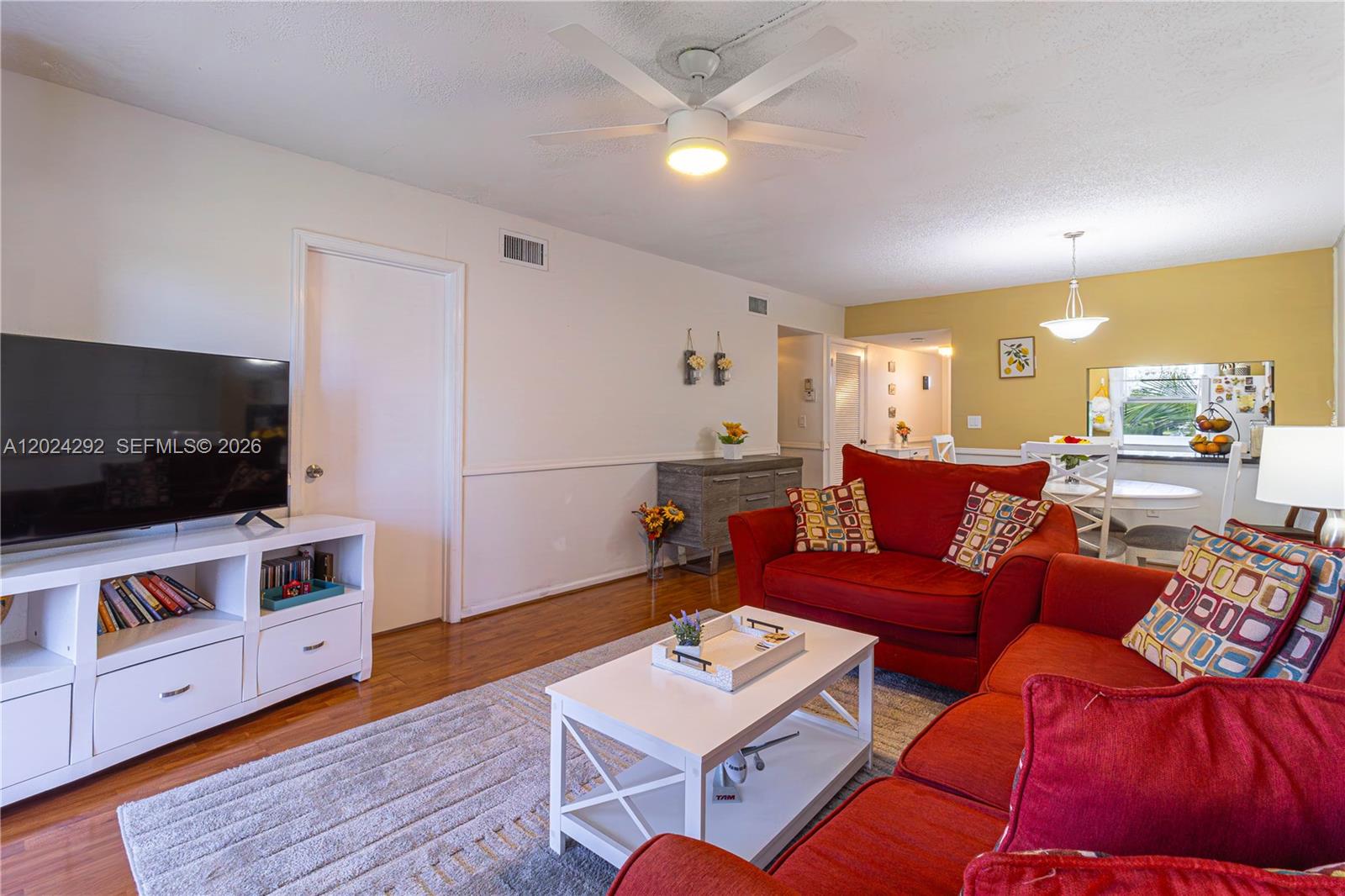 9780 Marina Boulevard, Unit 424 Boca Raton, FL 33428 - Photo 13 of 32 a living room with furniture and a flat screen tv