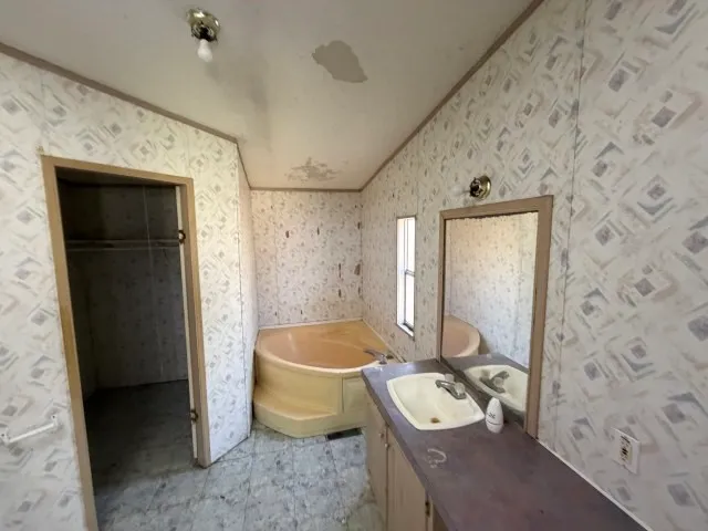 a bathroom with a tub sink and toilet