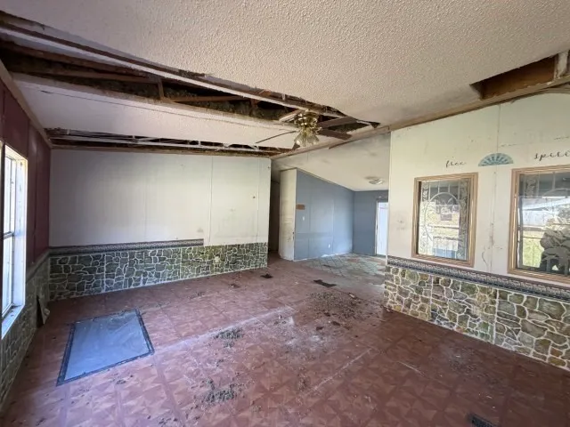 a view of an empty room with a chandeliers