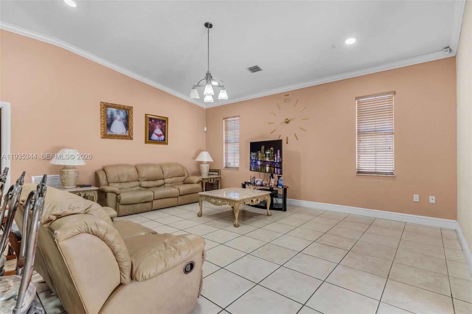 12700 Southwest 188th Street Miami, FL 33177 - Photo 13 of 44 a living room with furniture and a chandelier