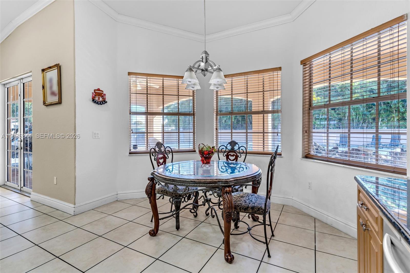 12700 Southwest 188th Street Miami, FL 33177 - Photo 15 of 44 a dining room with furniture a chandelier and window