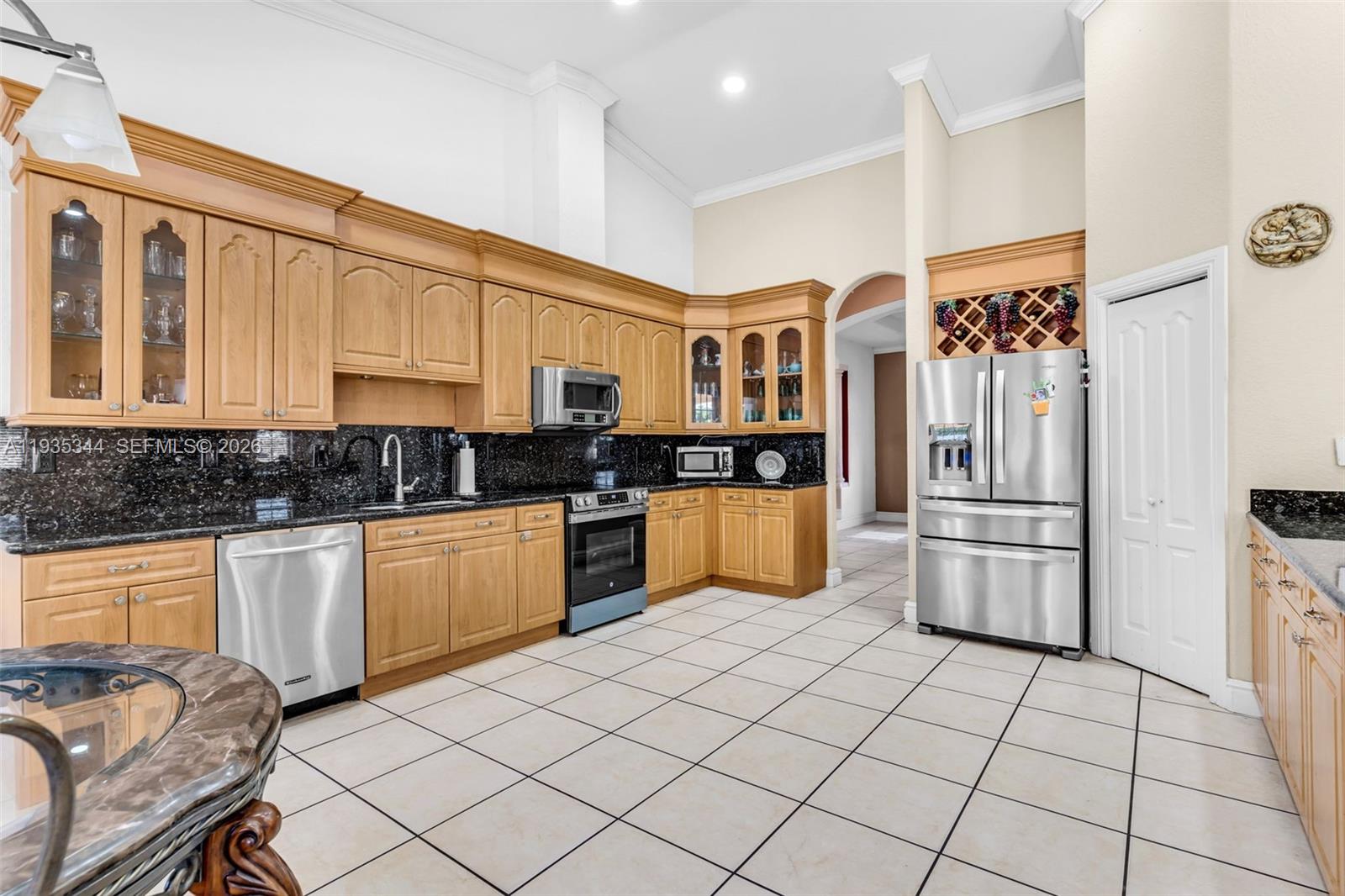 12700 Southwest 188th Street Miami, FL 33177 - Photo 16 of 44 a kitchen with stainless steel appliances granite countertop a refrigerator and a stove top oven