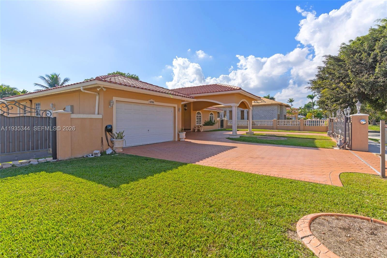 12700 Southwest 188th Street Miami, FL 33177 - Photo 2 of 44 a front view of a house with a yard