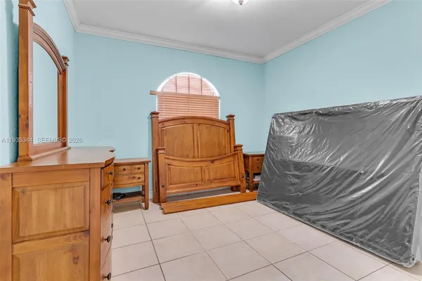 a bedroom with a bed and a dresser