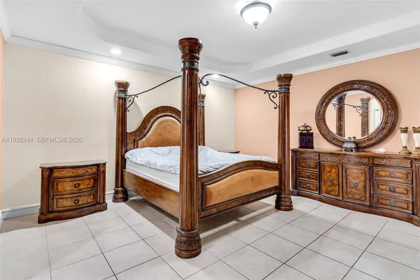 a bedroom with a bed and a mirror