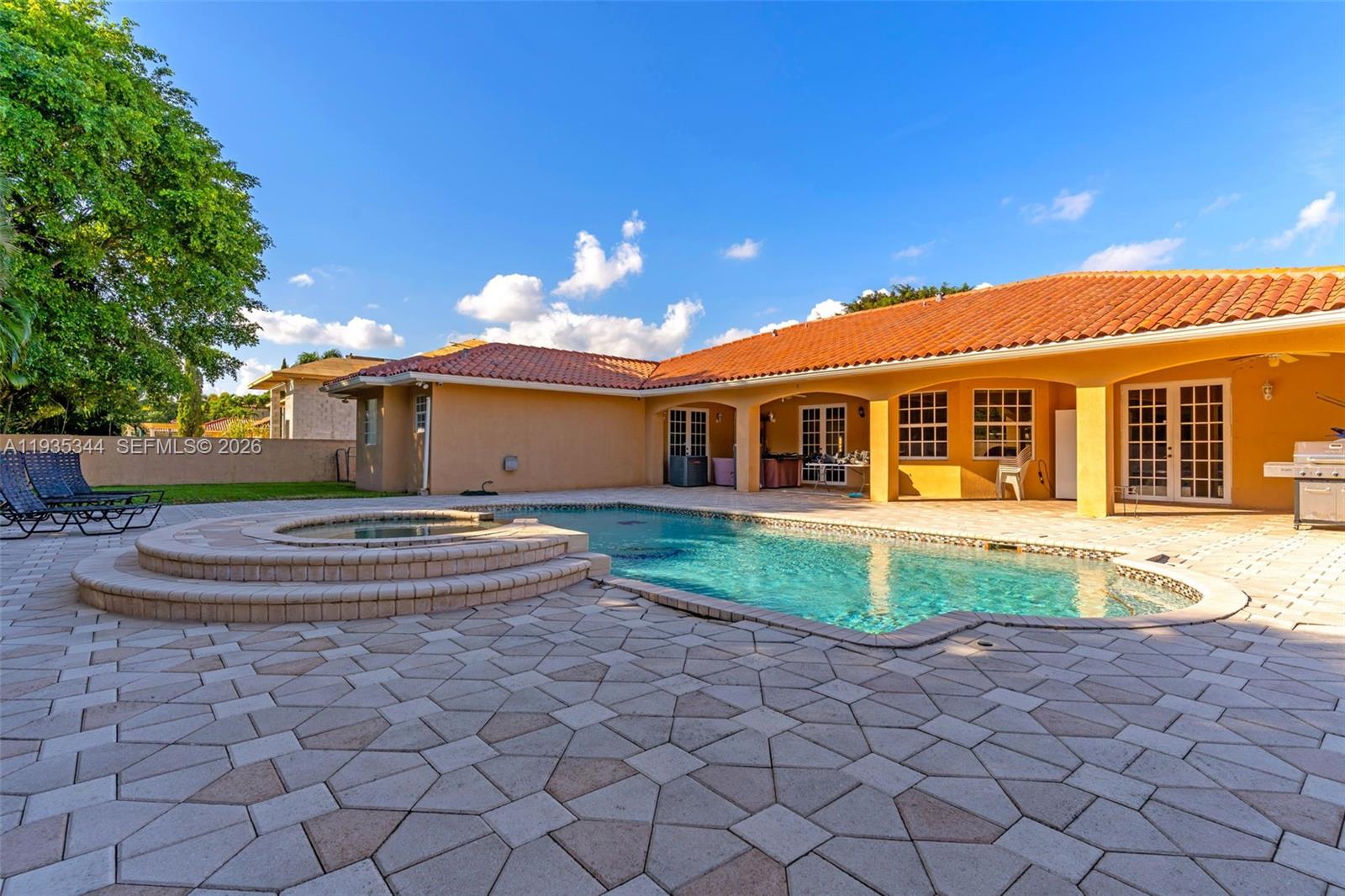 12700 Southwest 188th Street Miami, FL 33177 - Photo 32 of 44 a front view of a house with a yard